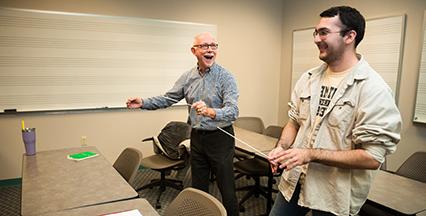 A music student and teacher conducting